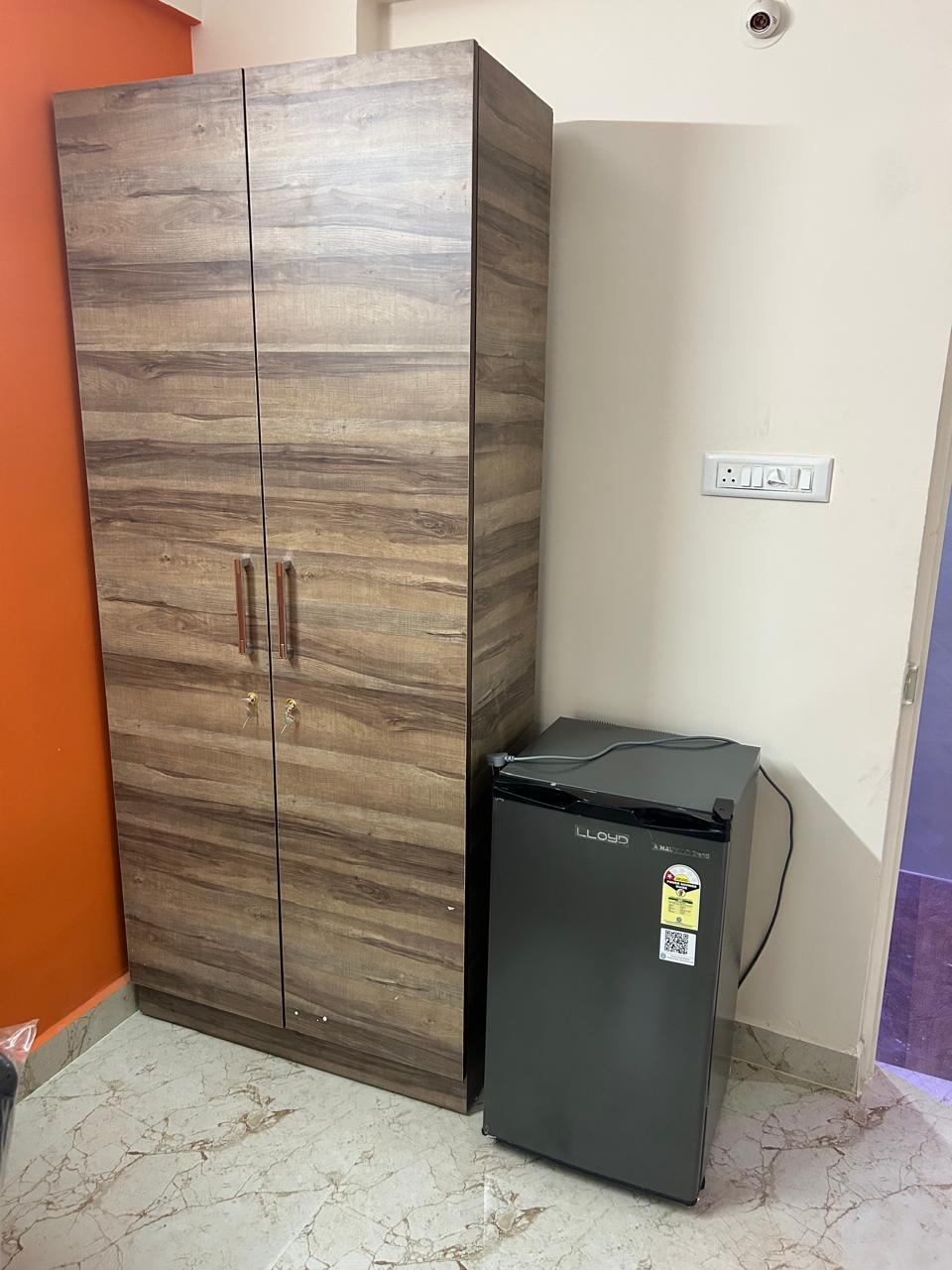 Rest and Roam Co-Live wardrobe and Lloyd fridge